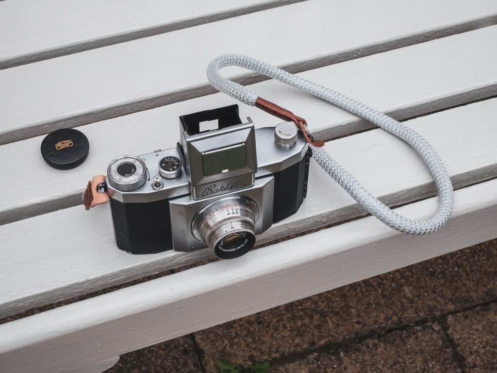 Praktiflex camera from above with original lens cap.